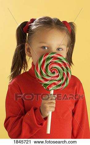 Stock Image - Child with a lollipop. Fotosearch
