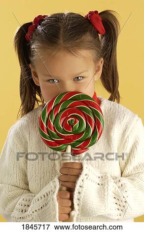 Stock Photo - Child with a lollipop. Fotosearch
