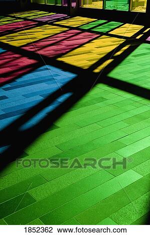Stock Image - Colorful windows; Reflection of stained glass window on the floor. Fotosearch