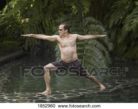Stock Image - Como Shambhala Estate, Bali, Indonesia; Man in yoga position. Fotosearch