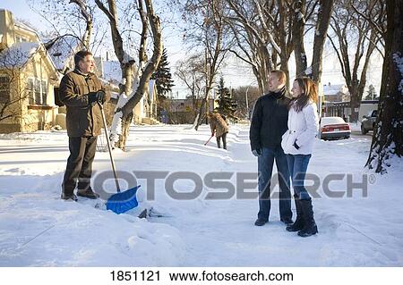 Stock Image - Couple and man with shovel. Fotosearch