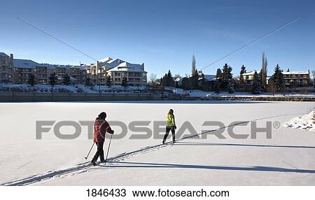 Stock Image - Couple cross-country skiing. Fotosearch
