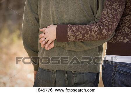 Couple holding hands View Large Photo Image Stock Photograph - Couple holding hands. Fotosearch