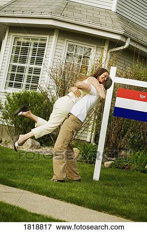 Couple hugging; Couple sells their home View Large Photo Image Stock Photo - Couple hugging; Couple sells their home. Fotosearch