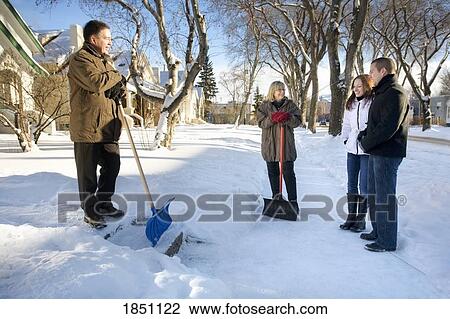 Couples visiting outside in the snow View Large Photo Image Stock Image - Couples visiting outside in the snow. Fotosearch