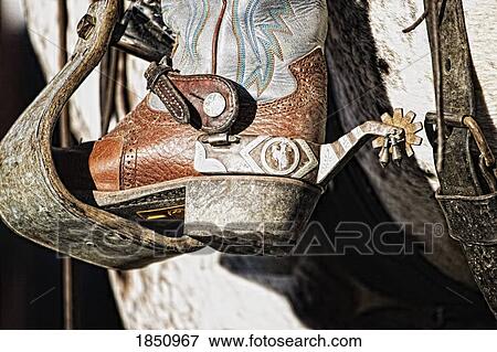 Cowboy boot heel and spur in saddle stirrup View Large Photo Image Stock Photo - Cowboy boot heel and spur in saddle stirrup . Fotosearch