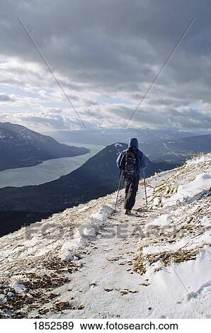 Stock Photo - Dog Mountain, Washington, USA; Hiker on snow-covered trail. Fotosearch