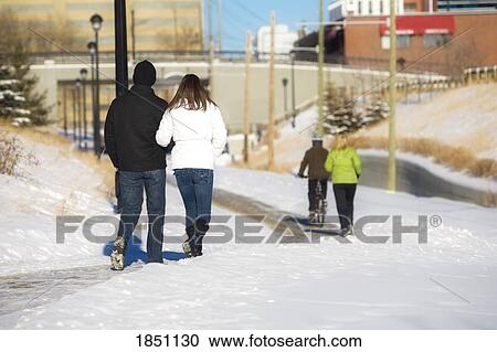 Stock Image - Edmonton, Alberta, Canada; Two couples walking on a path. Fotosearch