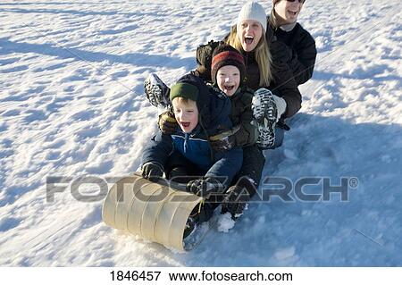 Stock Photo - Family tobogganing. Fotosearch