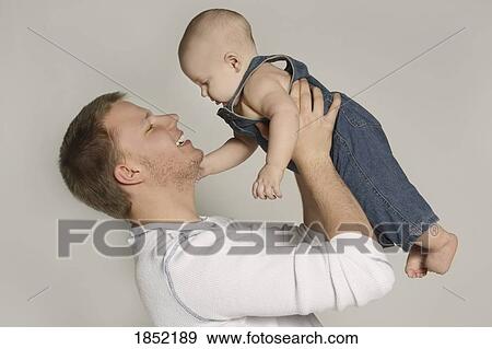 Stock Photo - Father and child; Portrait of father and baby. Fotosearch