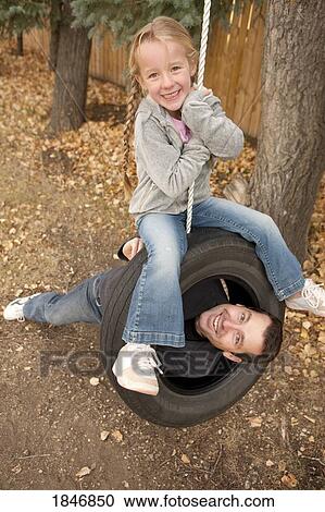 Father and daughter on tire swing View Large Photo Image Stock Image - Father and daughter on tire swing. Fotosearch