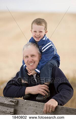 Father and son; Boy on his father's shoulders View Large Photo Image Stock Image - Father and son; Boy on his father's shoulders. Fotosearch