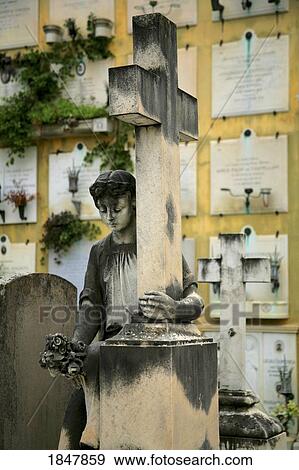 Stock Photo - Florence, Italy; Statue of woman holding a cross. Fotosearch
