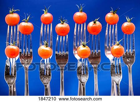 Stock Image - Forks with cherry tomatoes. Fotosearch