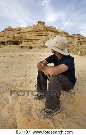 Stock Photo - Fortress of Shali, Siwa Town, Siwa Oasis, Egypt, Africa; A tourist sitting in front of the ruins. Fotosearch