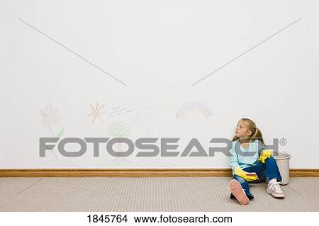 Girl cleaning drawing on the wall View Large Photo Image Picture - Girl cleaning drawing on the wall. Fotosearch