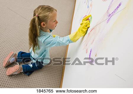 Girl cleaning drawing on the wall View Large Photo Image Stock Photography - Girl cleaning drawing on the wall. Fotosearch