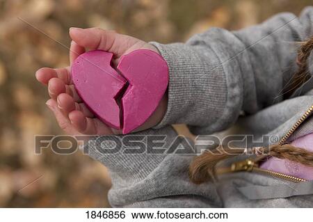 Girl holding broken heart View Large Photo Image Stock Photograph - Girl holding broken heart. Fotosearch