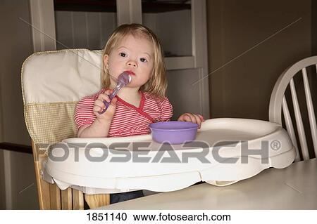 Stock Image - Girl in a high chair. Fotosearch