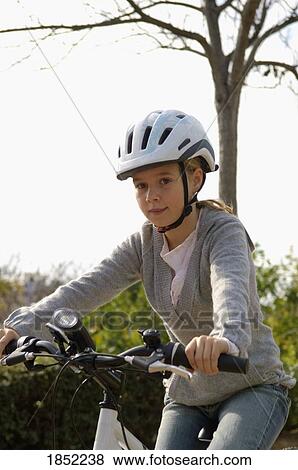 Girl on bike; Child rides on bicycle View Large Photo Image Stock Photo - Girl on bike; Child rides on bicycle. Fotosearch