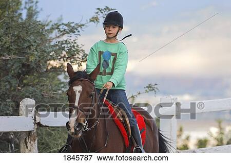 Girl riding a horse View Large Photo Image Stock Photo - Girl riding a horse. Fotosearch