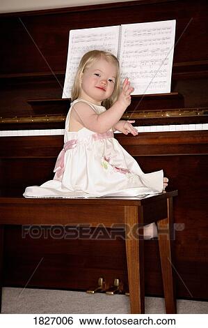 Girl sitting on piano bench View Large Photo Image Stock Photograph - Girl sitting on piano bench. Fotosearch