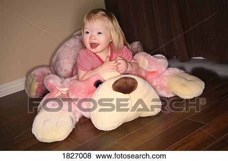 Girl sitting on stuffed animal View Large Photo Image Stock Photo - Girl sitting on stuffed animal. Fotosearch