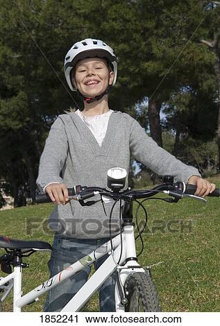 Girl with bike; Child standing beside bicycle View Large Photo Image Stock Image - Girl with bike; Child standing beside bicycle. Fotosearch