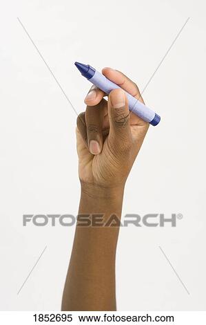 Stock Photography - Hand holding a wax crayon; Ready to color. Fotosearch