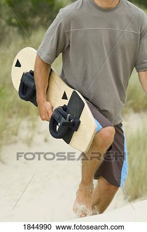 Stock Image - Honeyman State Park near Florence, Oregon, USA; Sandboarder. Fotosearch