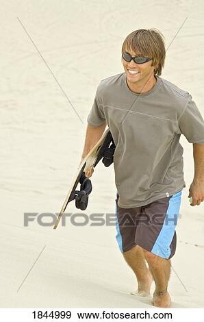 Stock Photo - Honeyman State Park near Florence, Oregon, USA; Sandboarder. Fotosearch