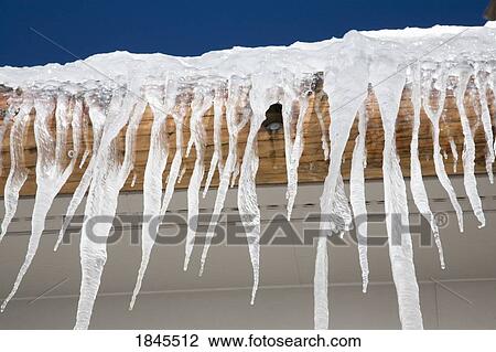 Stock Image - Icicles on a roof. Fotosearch