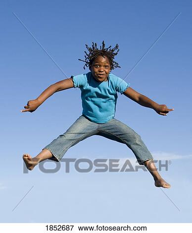 Stock Photo - Jumping for joy; Girl jumping in mid-air. Fotosearch