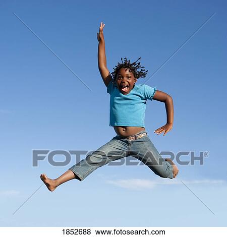 Stock Photo - Jumping for joy; Girl jumping in mid-air. Fotosearch