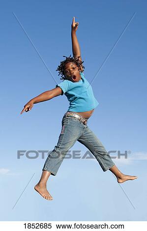 Stock Photography - Jumping for joy; Girl jumping in mid-air. Fotosearch