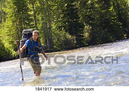 Kananaskis, Alberta, Canada; Man crossing a river View Large Photo Image Stock Photo - Kananaskis, Alberta, Canada; Man crossing a river. Fotosearch