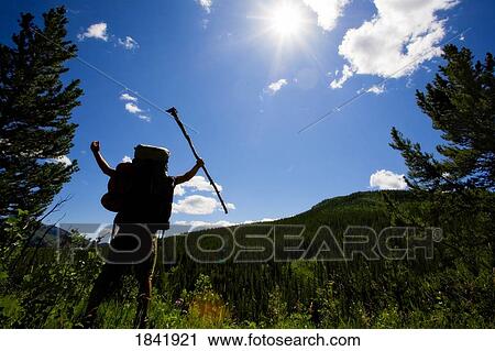 Stock Image - Kananaskis, Alberta, Canada; Man with his arms raised to the sky. Fotosearch