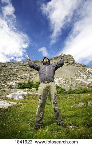 Kananaskis, Alberta, Canada; Man with his arms raised View Large Photo Image Stock Image - Kananaskis, Alberta, Canada; Man with his arms raised. Fotosearch