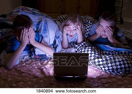 Kids watching scary movie View Large Photo Image Picture - Kids watching scary movie. Fotosearch