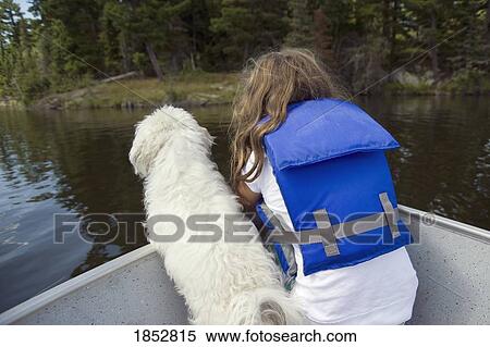 Lake of the Woods, Lulu, Ontario, Canada; Little girl with little white dog in boat View Large Photo Image Stock Photography - Lake of the Woods, Lulu, Ontario, Canada; Little girl with little white dog in boat . Fotosearch