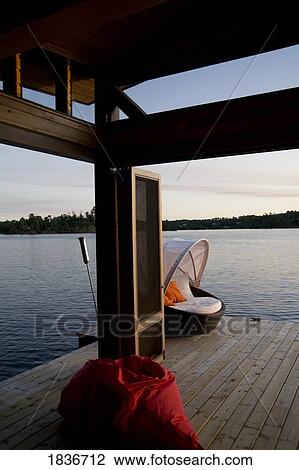 Lake of the Woods, Ontario, Canada; Lounge chair on dock View Large Photo Image Stock Image - Lake of the Woods, Ontario, Canada; Lounge chair on dock. Fotosearch