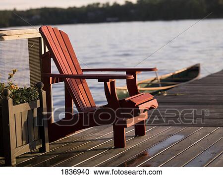 Stock Image - Lake of the Woods, Ontario, Canada; Adirondack chair. Fotosearch