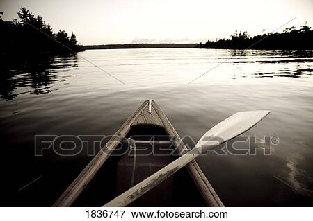 Stock Photo - Lake of the Woods, Ontario, Canada; Boat on the water. Fotosearch