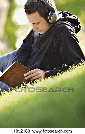 Listening to music and reading a book View Large Photo Image Stock Image - Listening to music and reading a book. Fotosearch