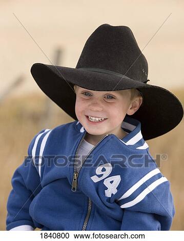 Stock Image - Little boy with a big hat. Fotosearch