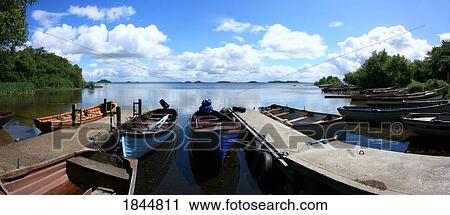 Stock Image - Lough Corrib near Oughterard, Co Galway, Ireland; Boats moored on the lake. Fotosearch