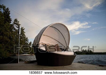 Lounging chair on a dock View Large Photo Image Stock Photo - Lounging chair on a dock. Fotosearch