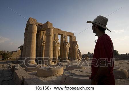Stock Photo - Luxor, Egypt; A tourist enjoying the view of the Ramesseum. Fotosearch