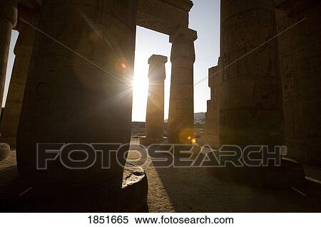 Stock Photography - Luxor, Egypt; The Ramesseum, Sunburst through the temple of Ramses II. Fotosearch