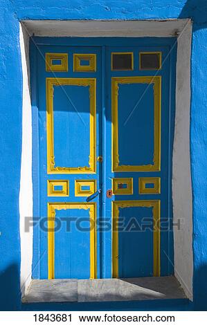 Stock Image - Macharaviaya, Andalucia, Spain; Blue and yellow door. Fotosearch